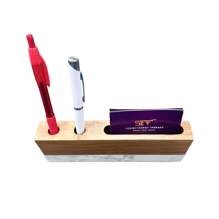 Desk organizer holding a red pen, blue pen, and purple card.