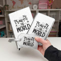 White passport wallets engraved with travel-themed designs.