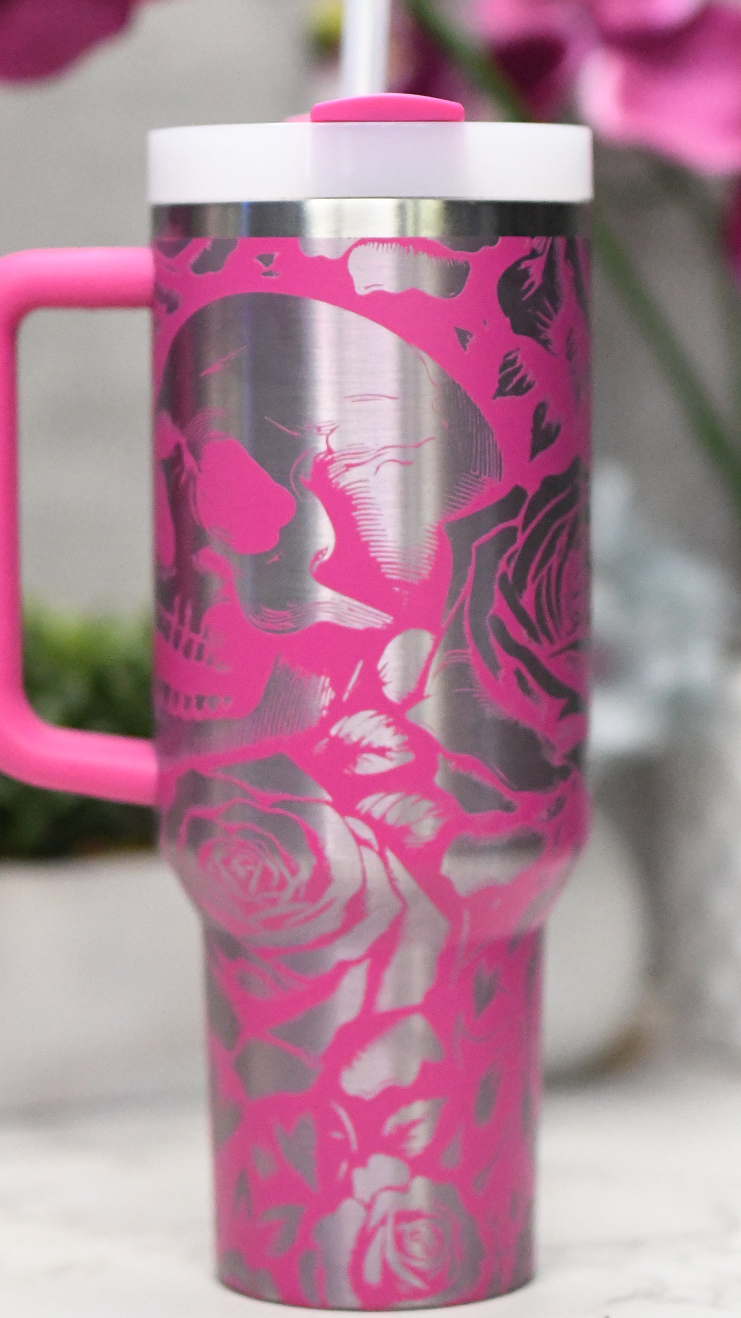 a pink and silver coffee cup with a pink handle