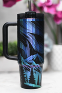 a blue and black travel mug sitting on top of a table