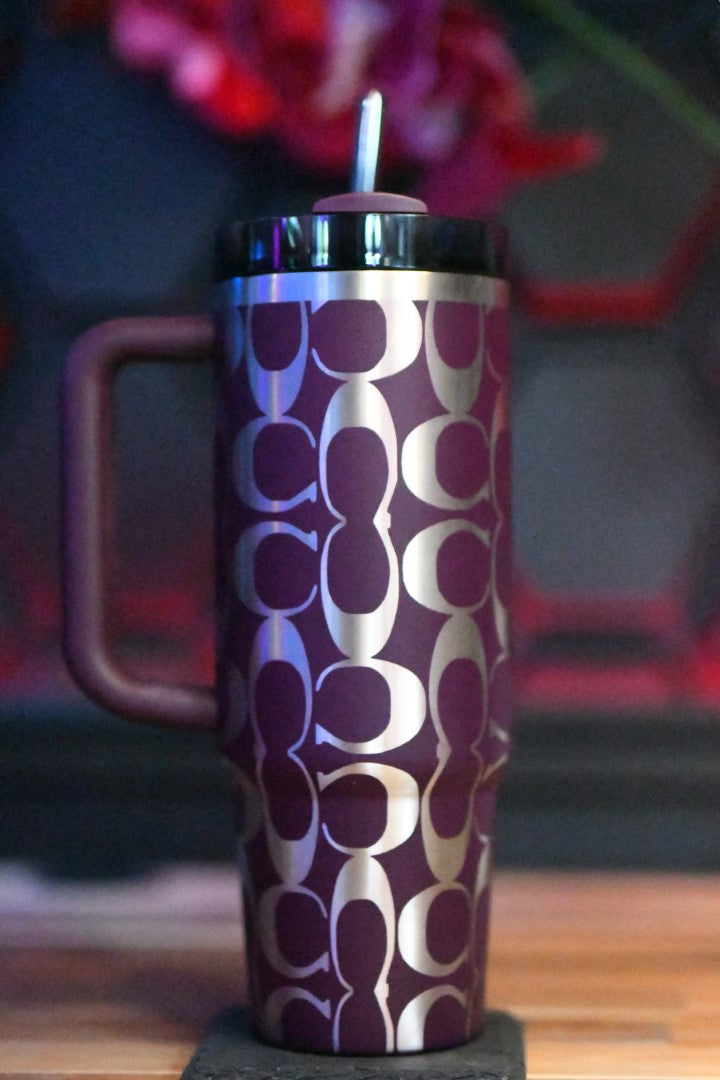 a purple and white cup sitting on top of a wooden table