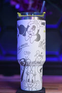 a tumbler cup with mickey mouse drawings on it