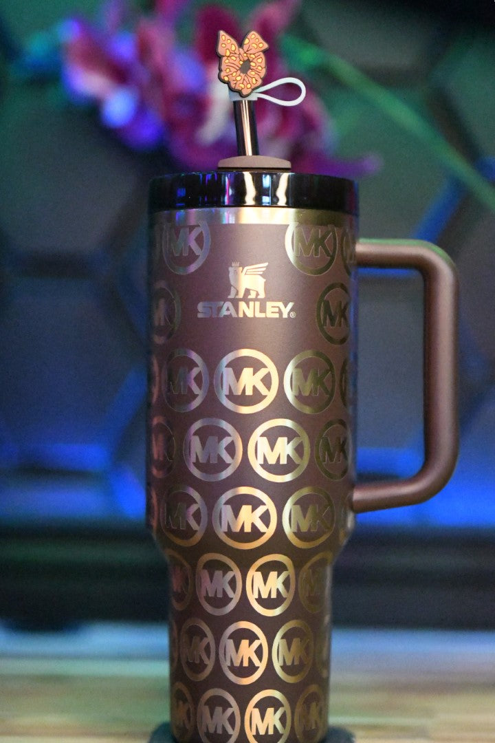 a travel mug with a butterfly on top of it