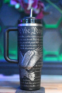 a travel mug with a bird on it sitting on a table