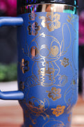 a blue coffee cup with gold designs on it