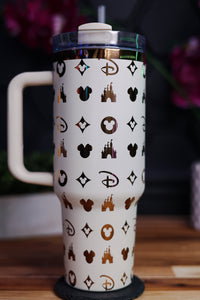 a white cup with a mickey mouse pattern on it