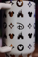 a coffee mug with a mickey mouse pattern on it