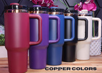 a group of different colored coffee mugs on a table