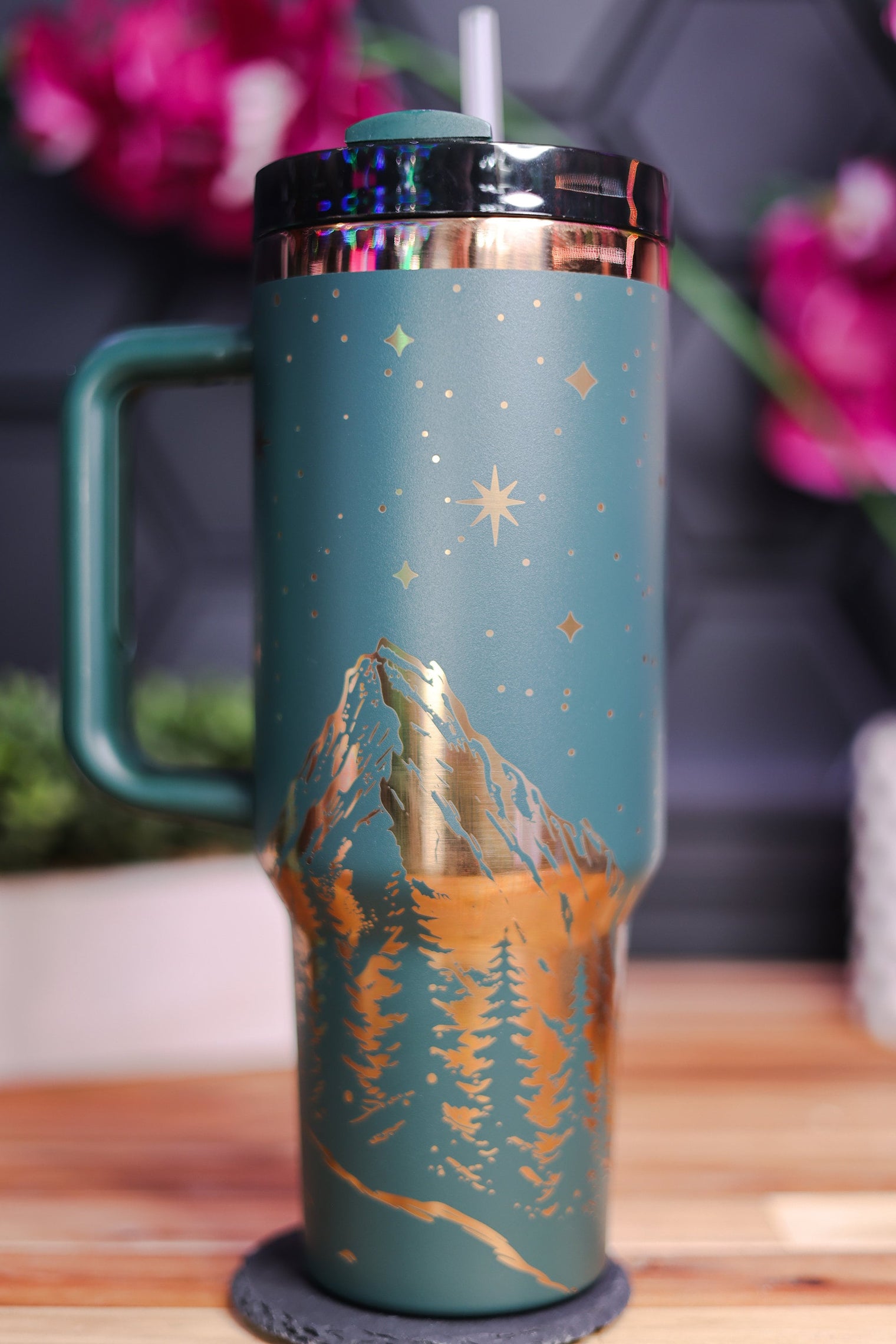 a travel mug with a mountain scene painted on it