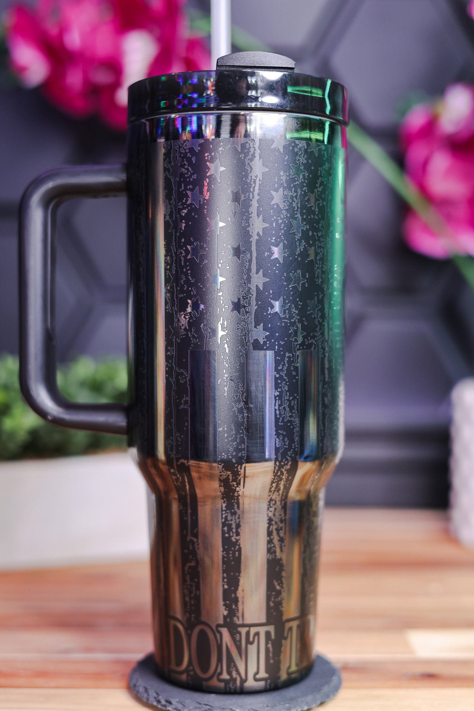 a black and gold coffee mug sitting on a wooden table