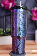 a stainless steel travel mug with a colorful design on it