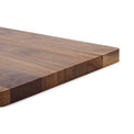 Close-up of the thick edge and end grain of the walnut board.