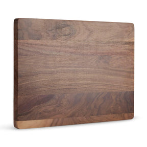 Solid walnut cutting board shown upright against white.