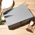 Closed gray memory box styled on a tabletop with accessories.