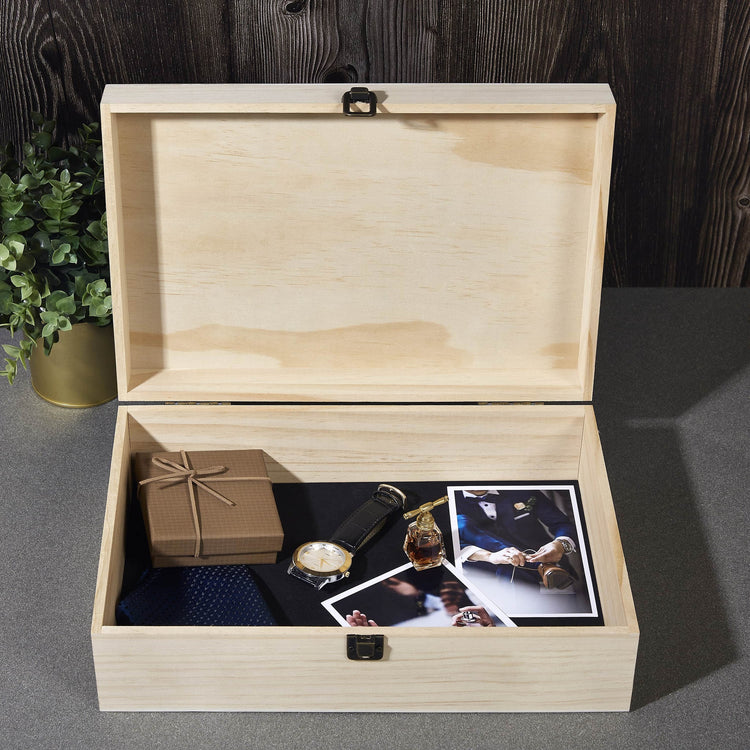 Open natural wood memory box holding photographs and keepsakes.