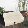 Closed natural wood memory box styled with plants and decor.