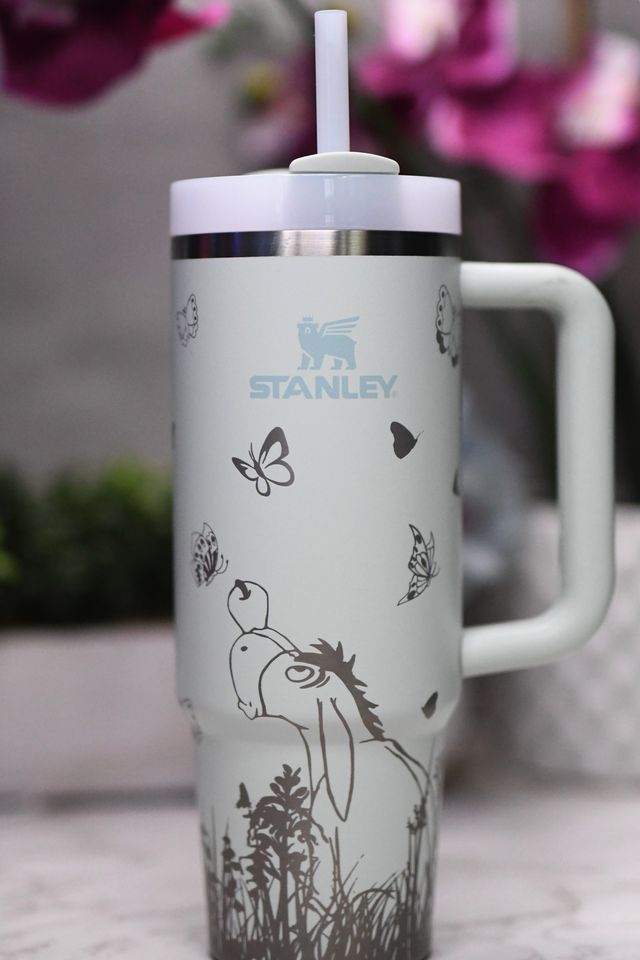 a white travel mug with a picture of a horse on it