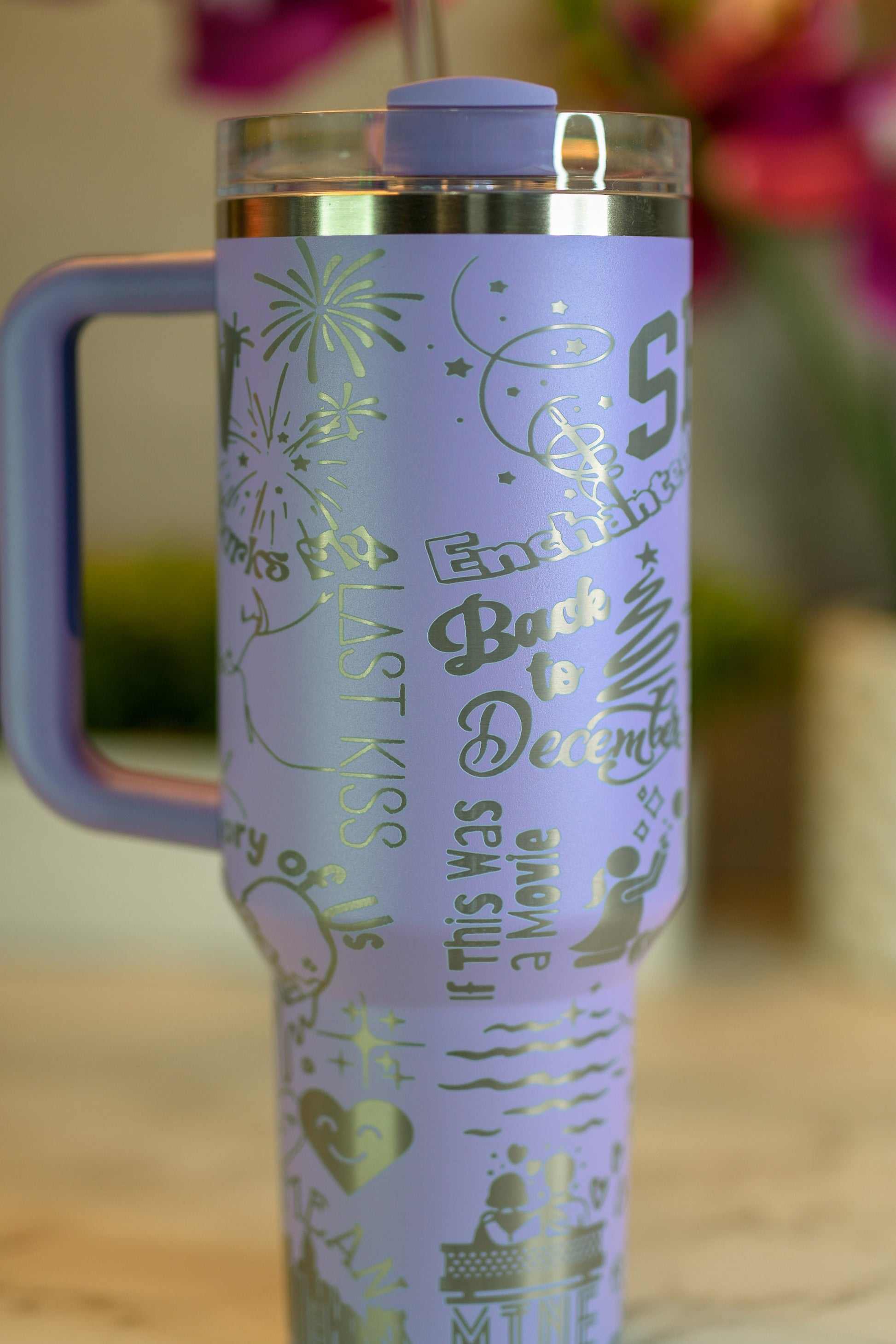 a purple travel mug sitting on top of a table