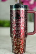 a red travel mug with a straw sticking out of it