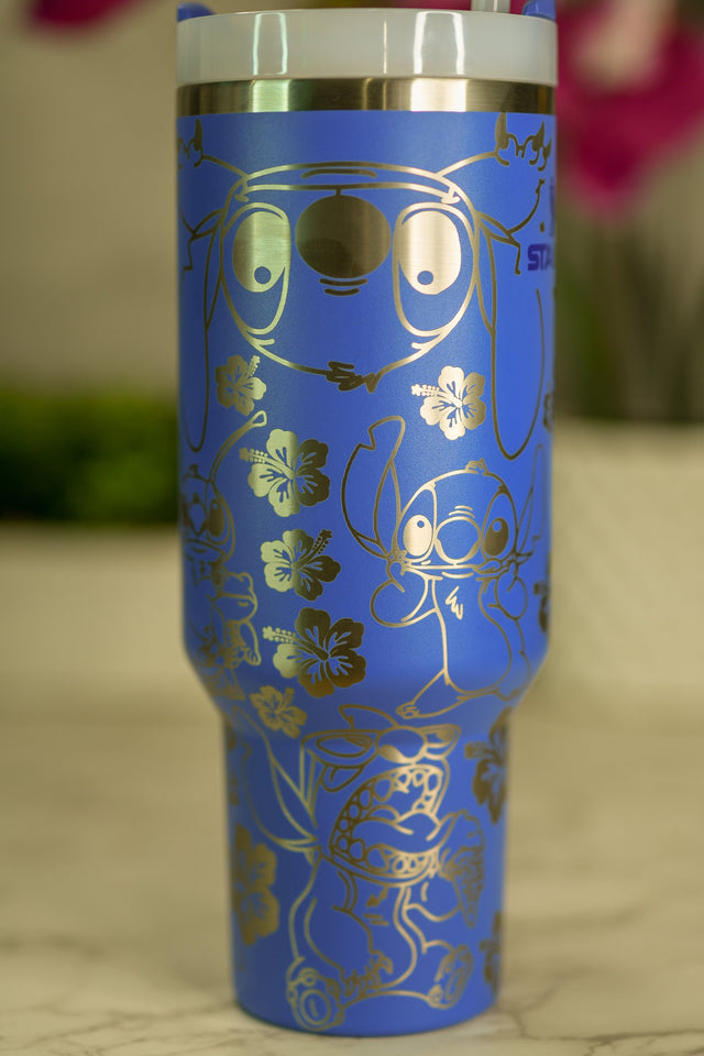 a blue cup with a gold design on it