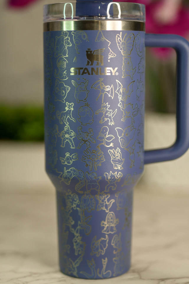 a blue travel mug with gold foiling on it