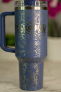 a blue and gold travel mug sitting on a table