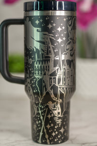 a travel mug with a picture of a castle on it