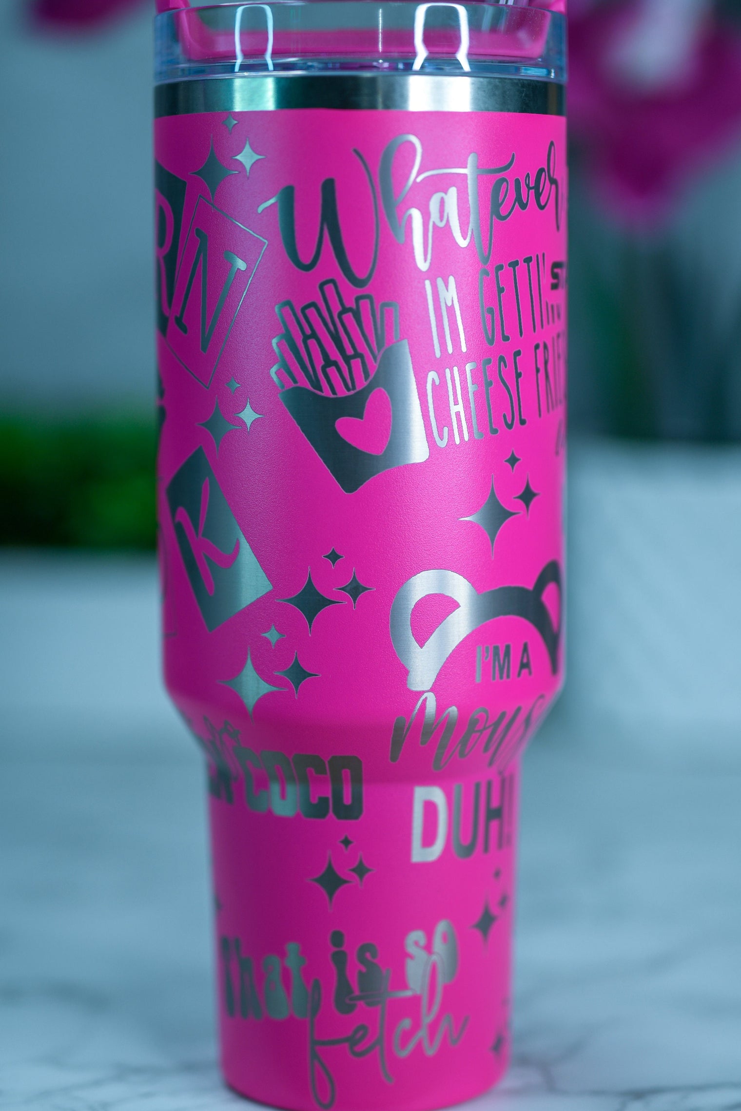 a pink tumbler cup sitting on top of a table