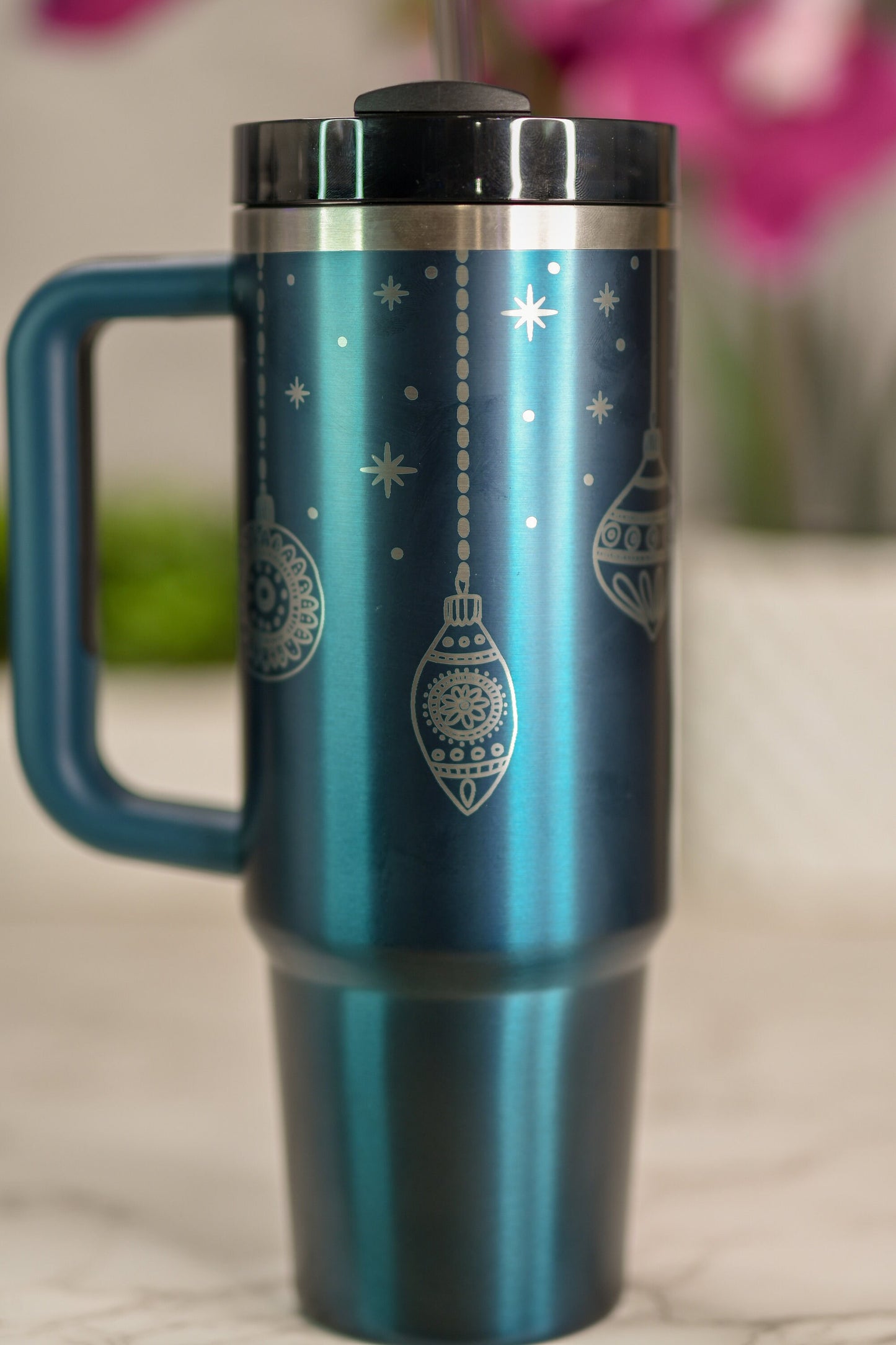 a blue travel mug with christmas ornaments on it