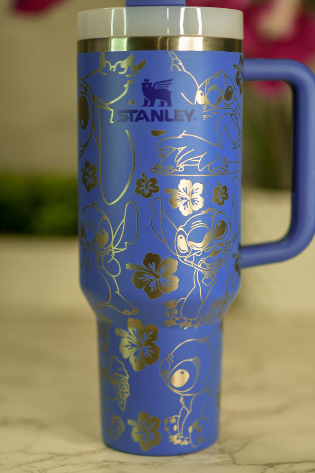 a blue and gold travel mug sitting on a table